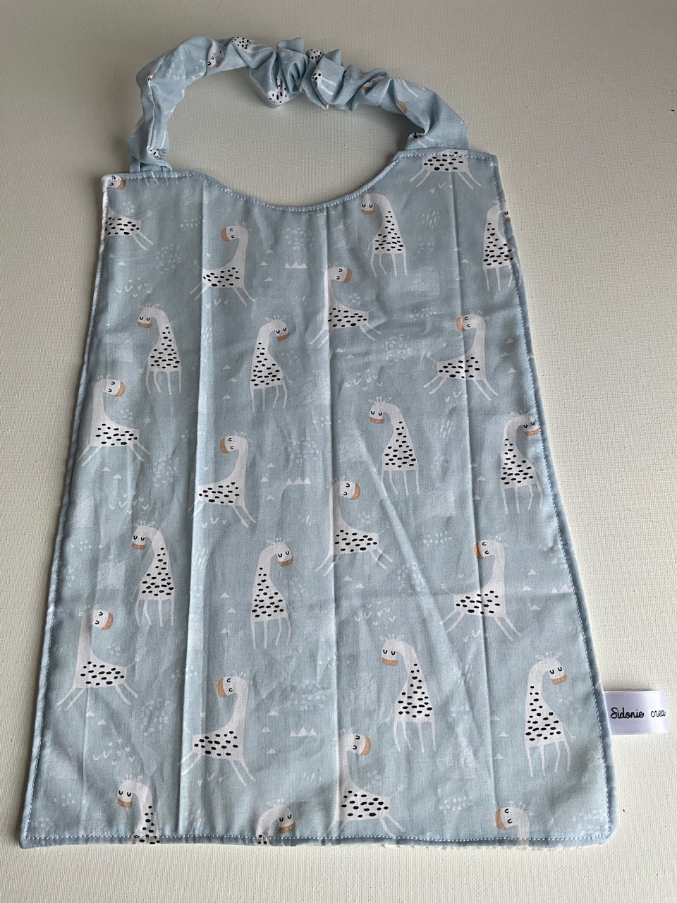 Serviette de cantine enfant dès 3 ans à encolure élastiquée, motif Girafes, coton imprimé et nid d'abeille